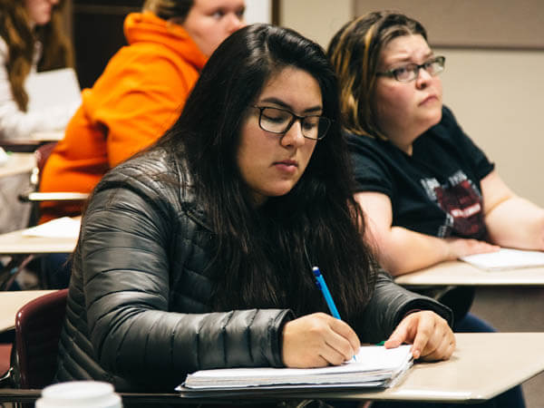 a student taking notes in class